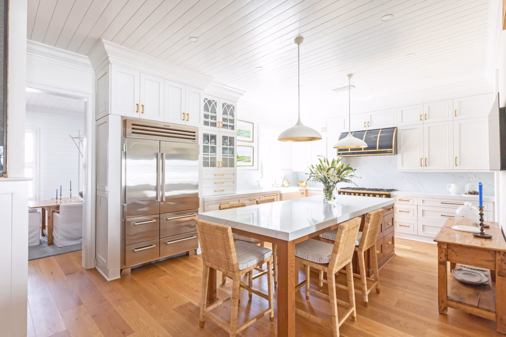 white kitchen cabinet colors paired with warm wood and stainless steel in a modern coastal custom home design in Charleston